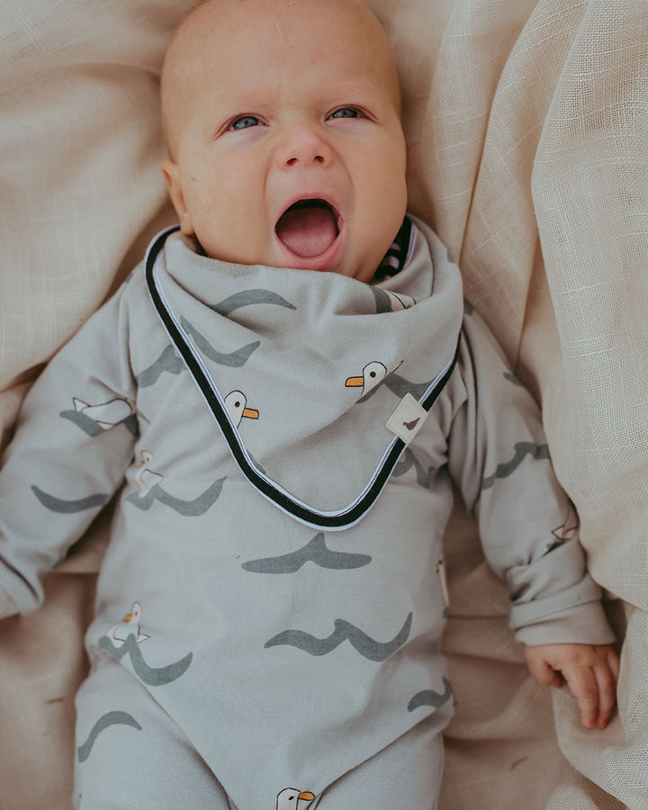 Baby wearing gender-neutral baby playsuit