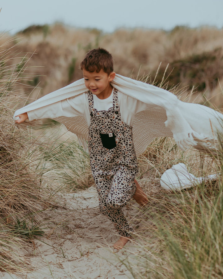 boy playing in Turtledove London dungarees 