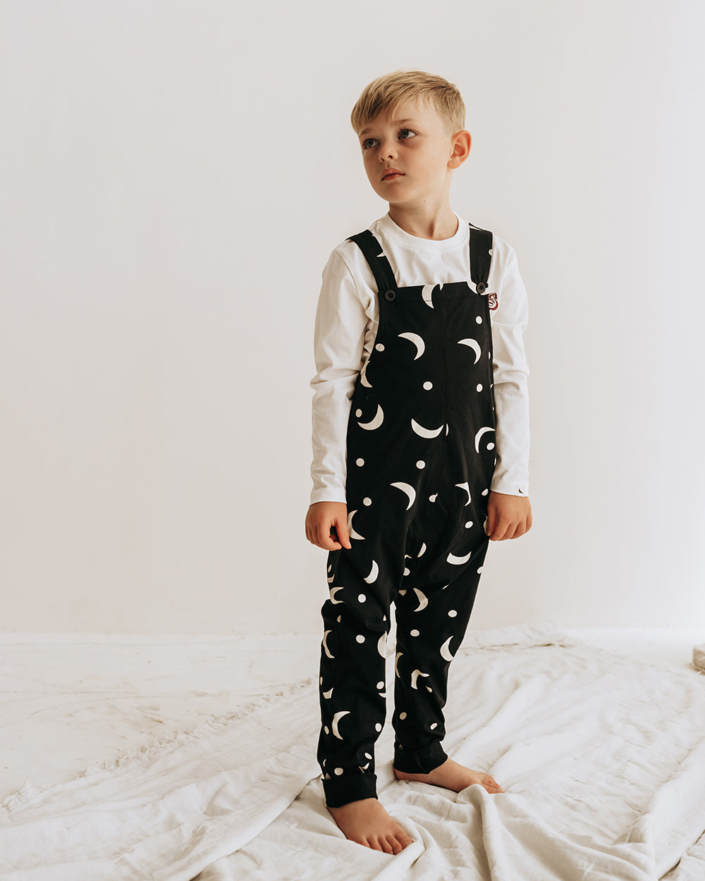 Boy wearing gender-neutral organic cotton kids dungarees