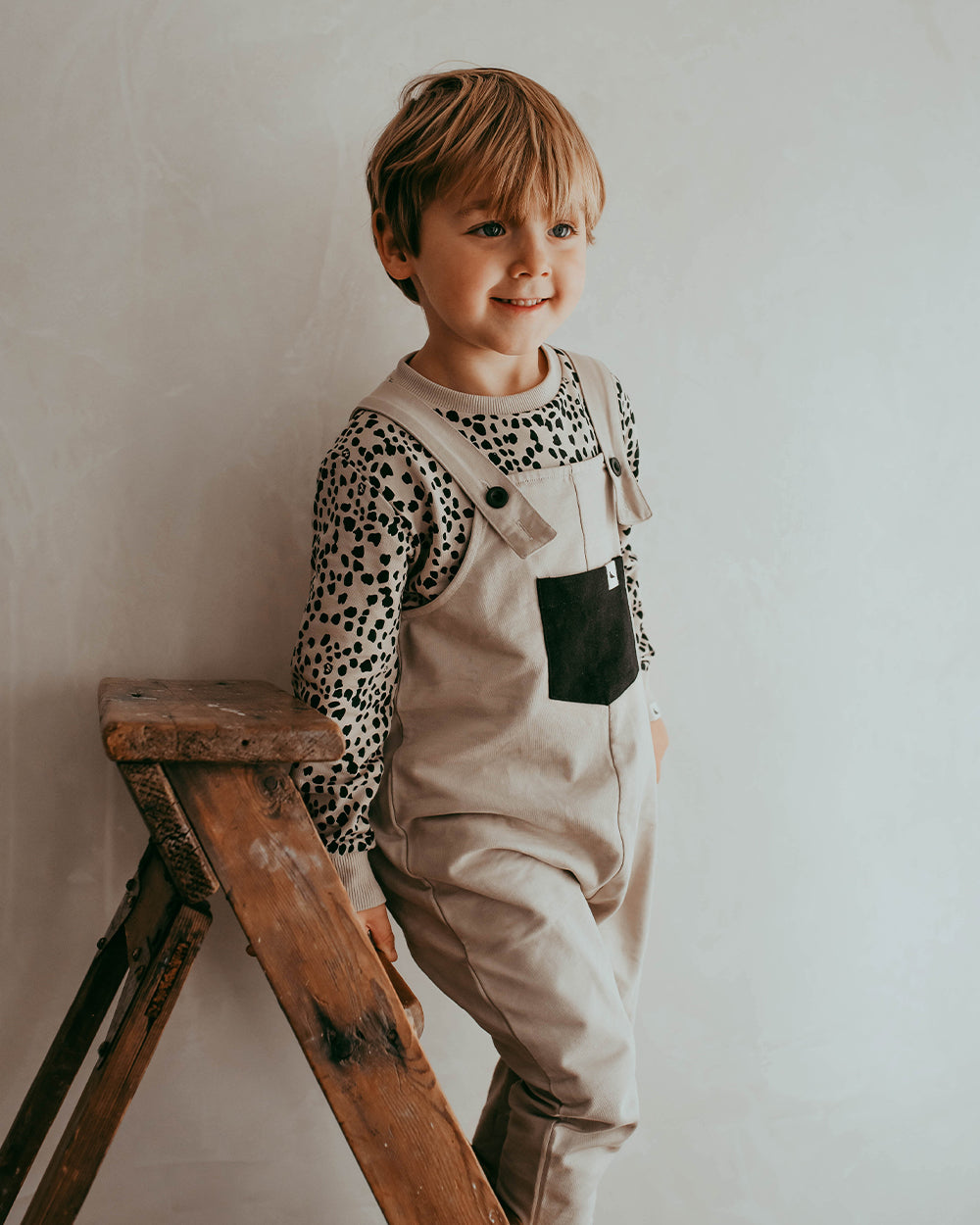 Boy wearing unisex organic cotton kids dungarees