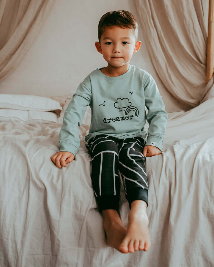 Boy wearing unisex organic cotton kids long-sleeve sweatshirt