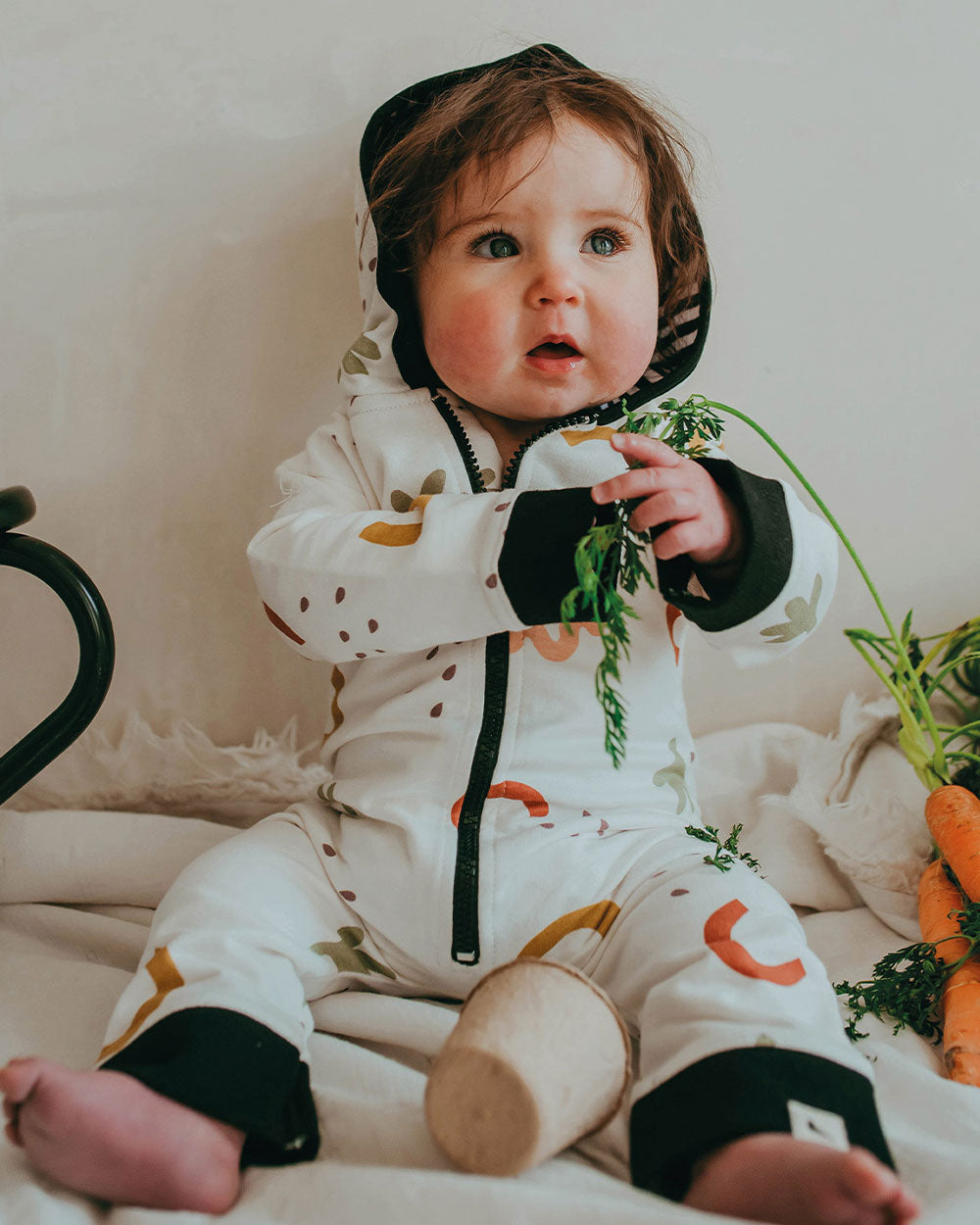 Baby wearing organic cotton ecru baby onesie