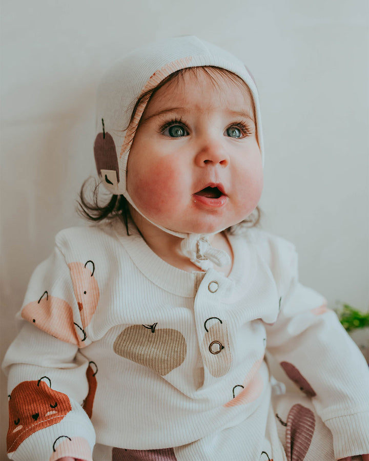 Baby girl wearing organic cotton baby bonnet