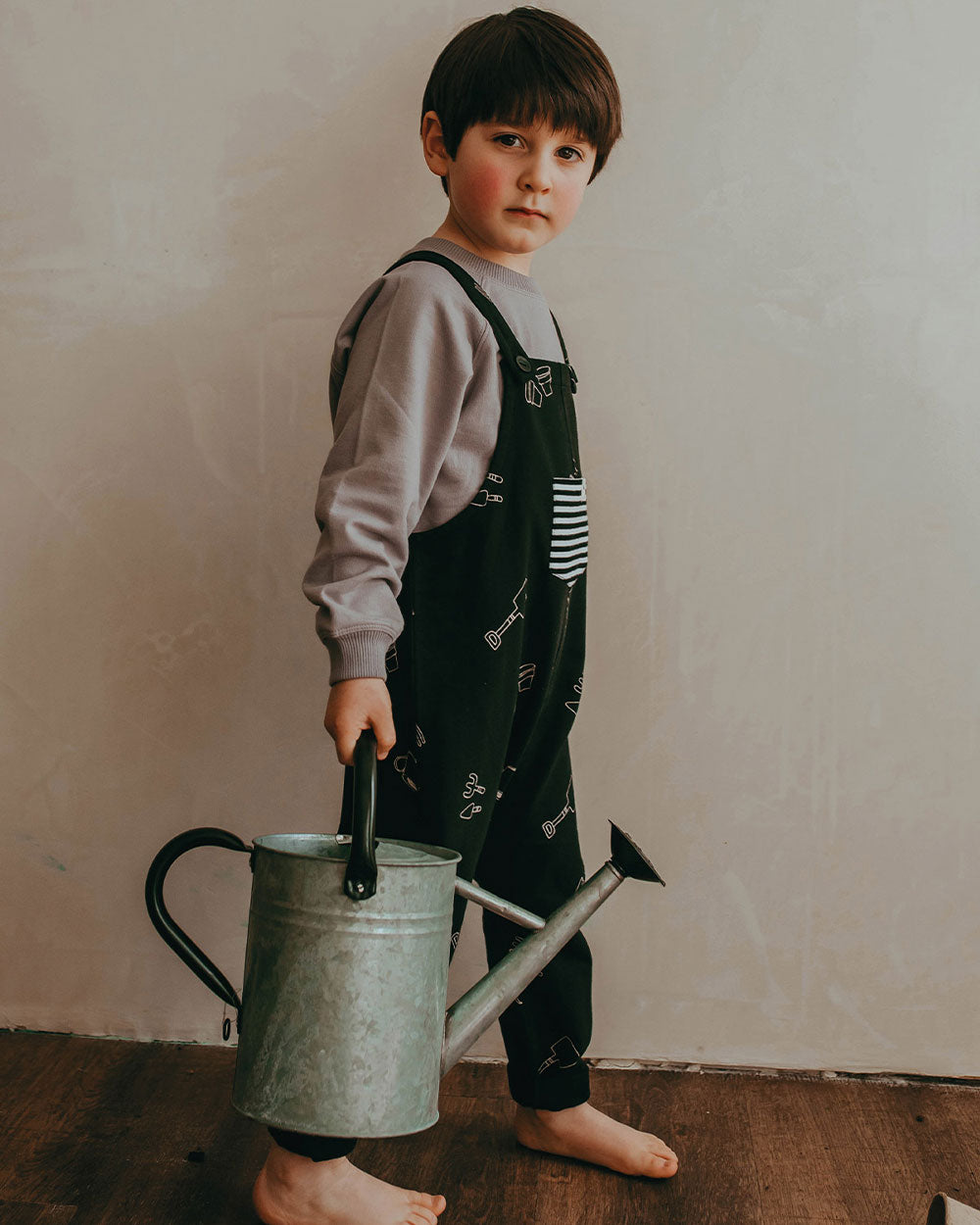Boy wearing organic cotton gender-neutral kids dungarees