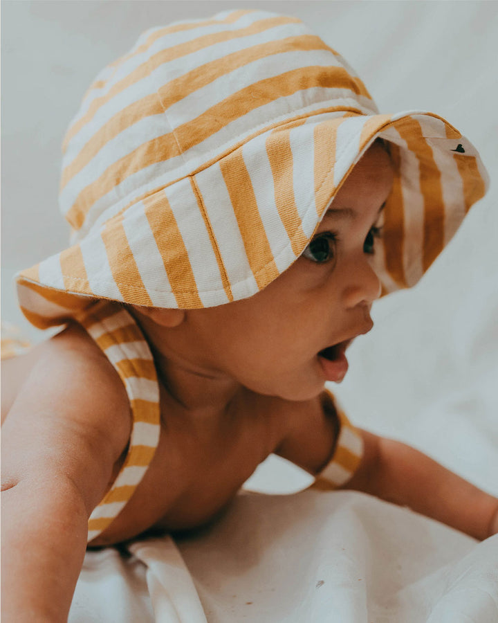Baby wearing gender-neutral organic cotton baby hat