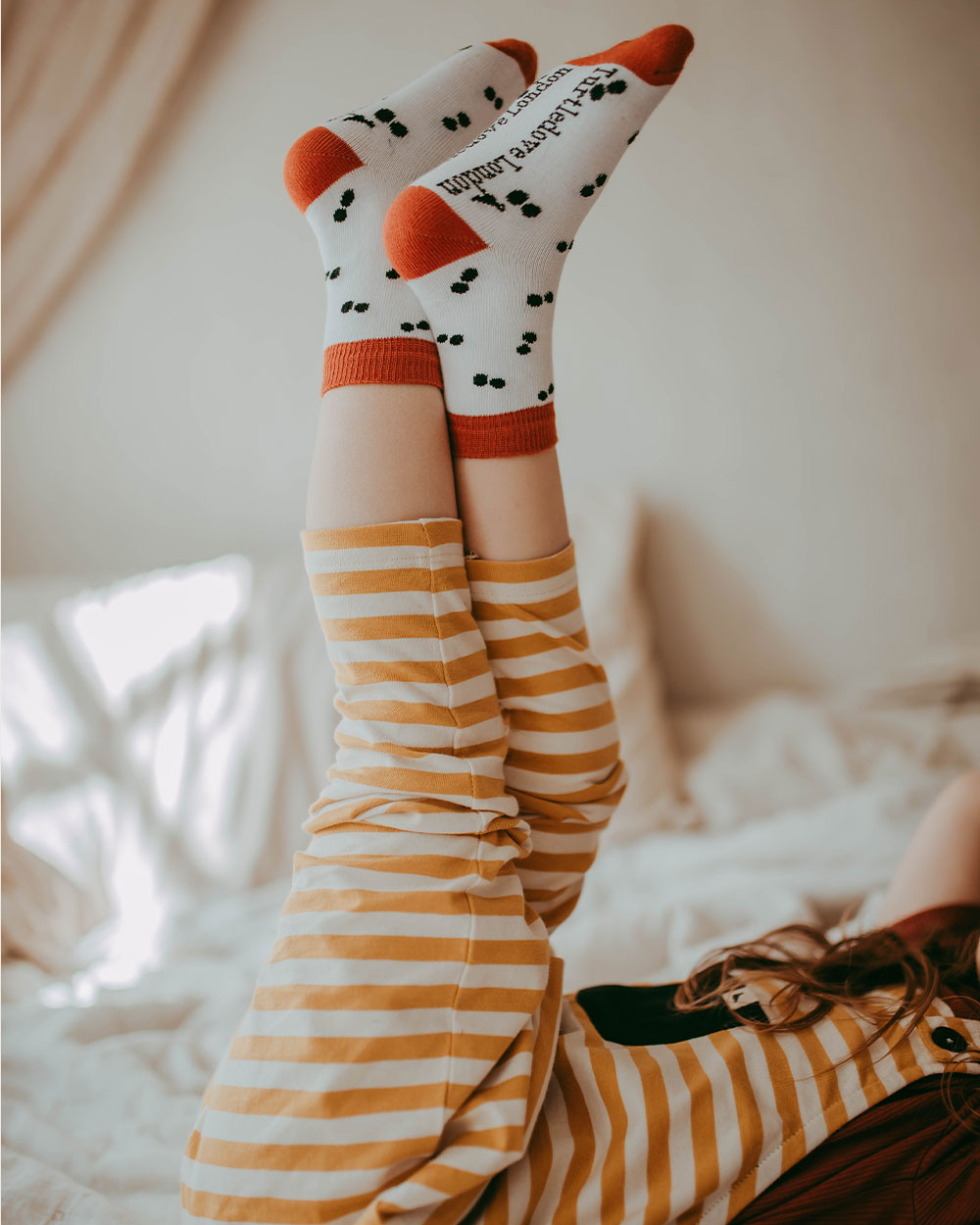 Girl wearing peapod printed socks for boys and girls